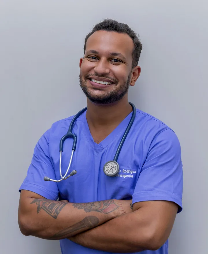 Portrait of Dr. James Okafor smiling in blue scrubs