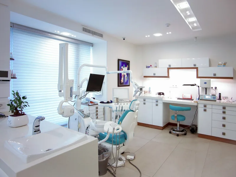 Bright treatment room with a large window, plants and modern equipment